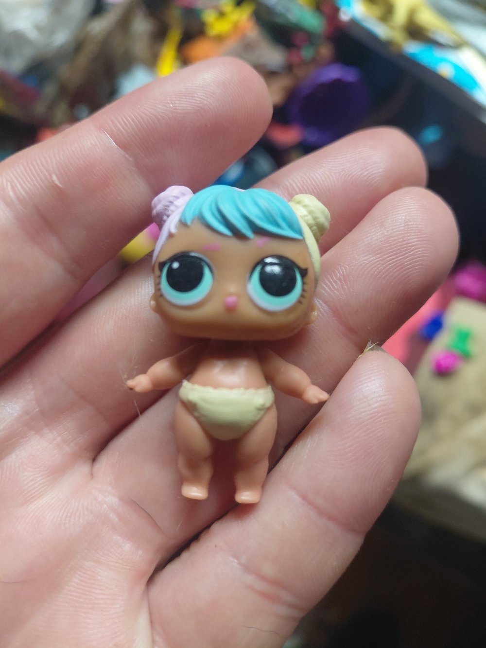 an L.O.L. Surprise! Lil Bon Bon collectible baby doll figure